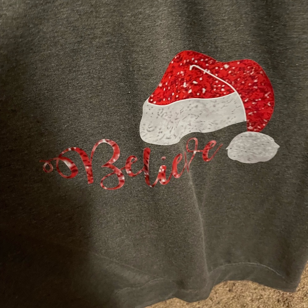 Cute Gray.sweat shirt with Santa hat and Believe on the front. Size Large